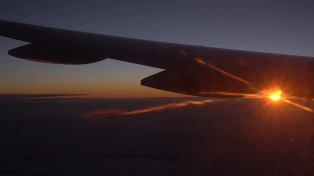 Clouds and beautiful sunrise. View from the window of an airplane wing, clouds and a beautiful sunrise.