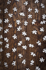 Puzzles on wooden background