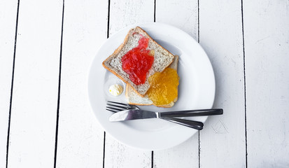 Toast with strawberry and orange yam on plate