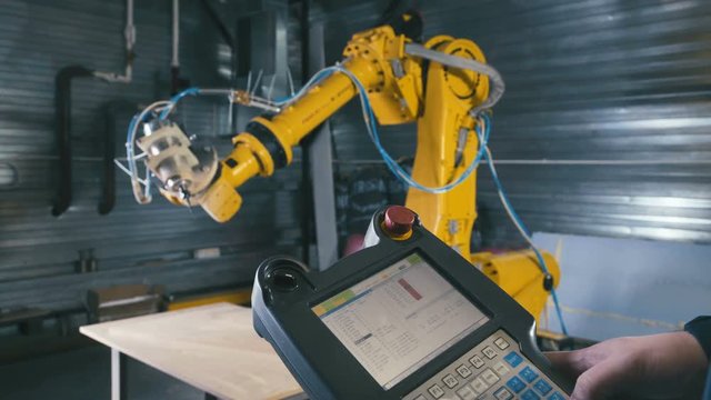 Engineer Using Automated Machine And manufacturing Wire. Machine tool for shaping or machining metal or other rigid material. Production of unmanned aerial vehicles (drones). 3D CNC Carver