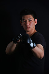 asian Fighter boxer standing strong on black background