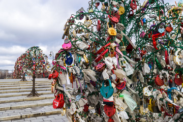 Metal trees with wedding padlocks on Luzhkov bridge in Moscow, Russia