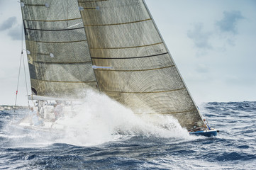 Sailing boat breaking waves