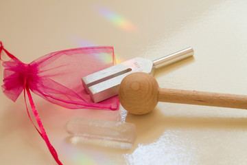 tuning fork and crystal on table .
