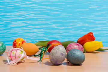 Easter in pool, wellness and relax. Eggs and water background for party and spa