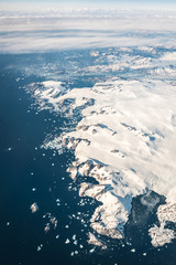 Greenland Mountain coastline  under the plane wings