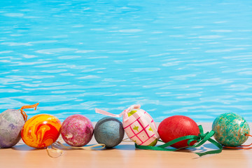 Easter in pool, wellness and relax. Eggs and water background for party and spa