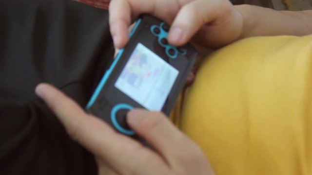 Close up of persons hands playing a game.