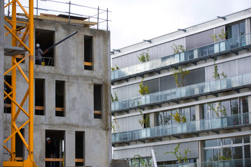 the construction crane and the building against the blue sky