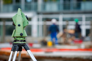Surveyor equipment theodolite on tripod at building area