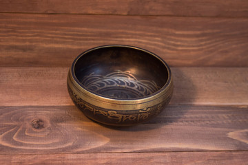 singing bowl on wooden background