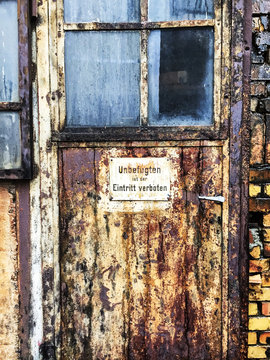 Old Door with Sign "Eintritt Verboten"