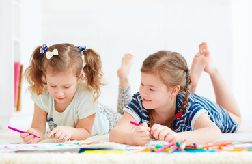 happy young girls, kids painting with felt pen together