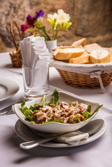 Luxury table with seafood appetizer in restaurant. Octopus salad in plate.