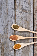 Food background with handmade spoons and spices.