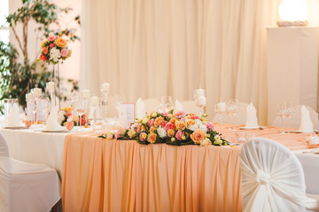 The elegant dinner table with flowers and cards