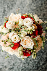 Wedding rings lie on a bouquet of fresh flowers