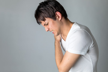 young man having a pain in his neck
