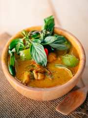 Vintage style Thai traditional food style spicy muslim curry (Massaman chicken curry) on wooden background wallpaper focus one point shallow with depth of field