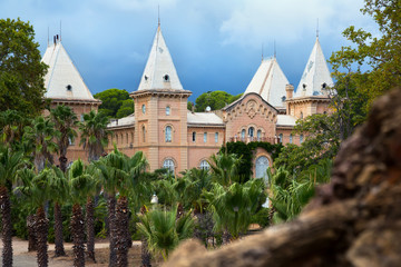 Fototapeta na wymiar Pavillion with several towers and Mediterranean garden in Sama Park, Catalonia