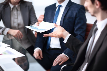 Image of business partners discussing documents and ideas at meeting