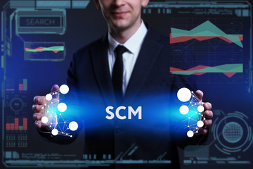 Business, Technology, Internet and network concept. Young businessman working on a virtual screen of the future and sees the inscription: SCM