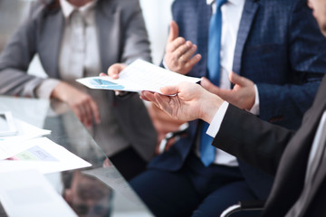 Image of business partners discussing documents and ideas at meeting