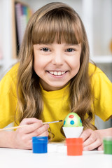 Easter holiday - kid coloring eggs
