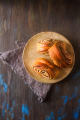 French bread on a wooden table. Dark background.