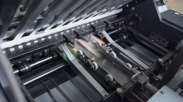 Offset printing press, printing production, industrial machine. Print house. 4k footage.
