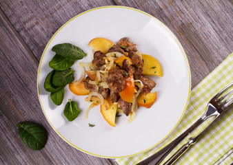 Liver with apple, spinach and onion. View from above, top studio shot