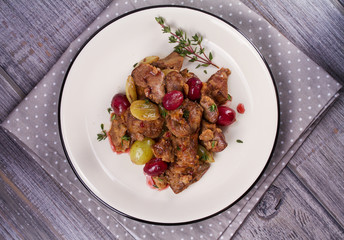 Liver with red and white grape garnished with thyme. View from above, top studio shot