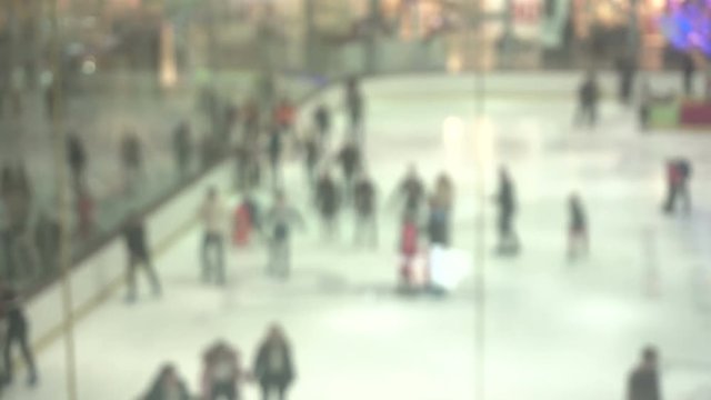 background with People skate on the ice at the mall