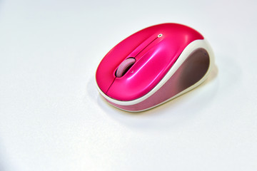 A wireless shocking pink color computer mouse