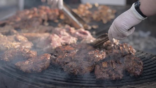 People cook barbecue grill, grilled steak, Frying fresh meat, Chicken BBQ, sausage, kebabs, hamburger, picnic with mushrooms and meat