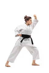 Foto auf Acrylglas Kampfkunst Girl wearing a kimono practicing karate