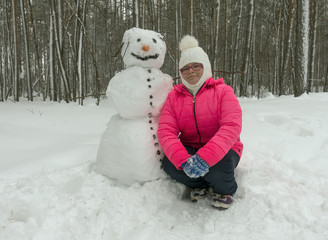Little girl with snowman