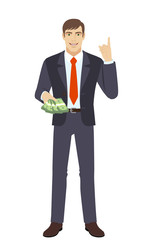 Businessman with money pointing index finger up