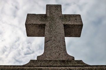 Genova (Genoa), Italy - February 22, 2017: A stone cross on a background of gray sky
