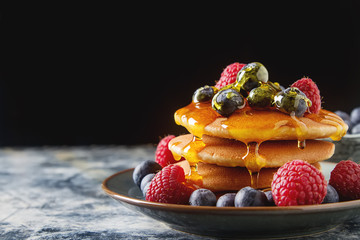 Stack of pancakes with fresh blueberry and maple syrup