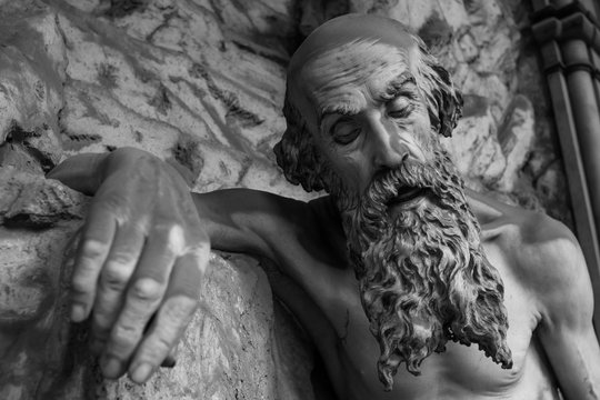 Genoa (Genova), Italy - February 22, 2017: An old man statue located in the cemetery of Genova Staglieno - black and white version