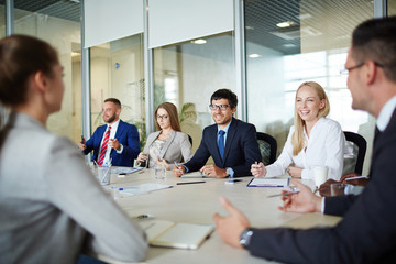 Team of managers discussing business strategies at briefing
