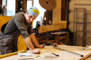 Repairman or cabinetmaker looking at sketch of new detail