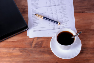 Computer laptop with notebooks, pen, pencil coffee cup on desk, business concept