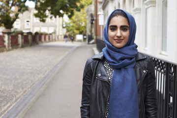 Portrait Of British Muslim Woman In Urban Environment