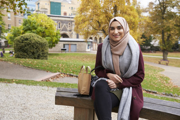 Fototapeta premium Portrait Of British Muslim Woman On Lunch Break In Park