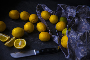 Ripe lemons in bag with knife