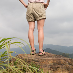 Woman enjoying pristine nature and beautiful view of tea plantations from the top of Small Adams...