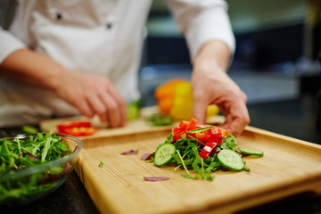 Fresh vegetarian salad on wooden board