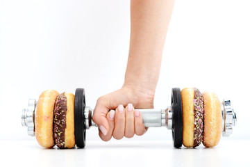 Healthy lifestyle concept suggested by weightlifting doughnuts